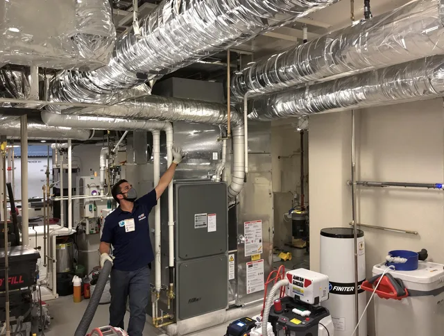 Wilmington Air Duct Cleaning specialist performing thorough furnace duct cleaning in a Wilmington residence