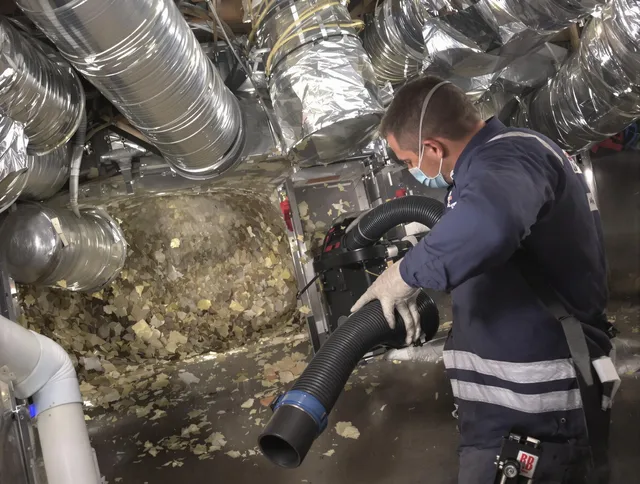 Wilmington Air Duct Cleaning specialist operating negative pressure cleaning equipment for thorough duct maintenance in Wilmington