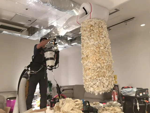 Wilmington Air Duct Cleaning technician performing precision vacuum insulation removal in a residential property in Wilmington